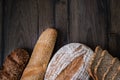 Bread. Assortment of different types of bread. Sliced Ã¢â¬ÂÃ¢â¬Â¹Ã¢â¬ÂÃ¢â¬Â¹bread on a wooden background. Loaf, bun, baguette, cereal bread.